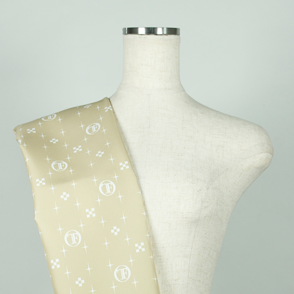 C0661　黄土色ベース白色モノグラム柄生地